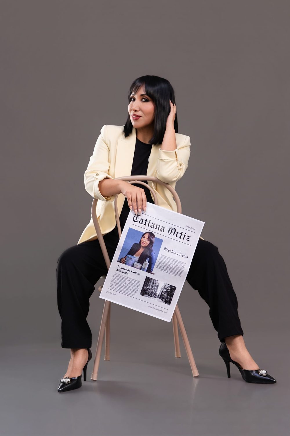 Tatiana Ortiz seated in a cream blazer holding her Tatiana Ortiz editorial